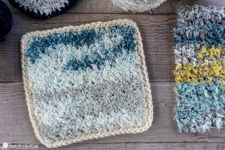 White, gray, and blue colorway of the scrubby yarn side of an example of the Two-Sided Scrubby Dishcloth.
