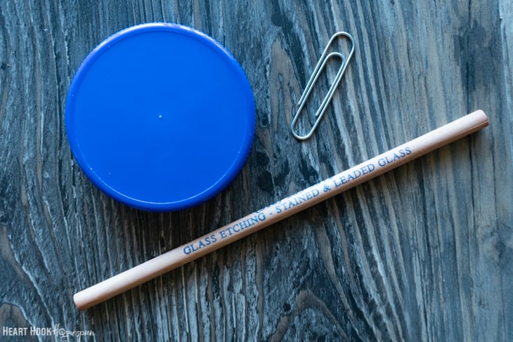 Blue lid, paper clip, and a wooden dowel.
