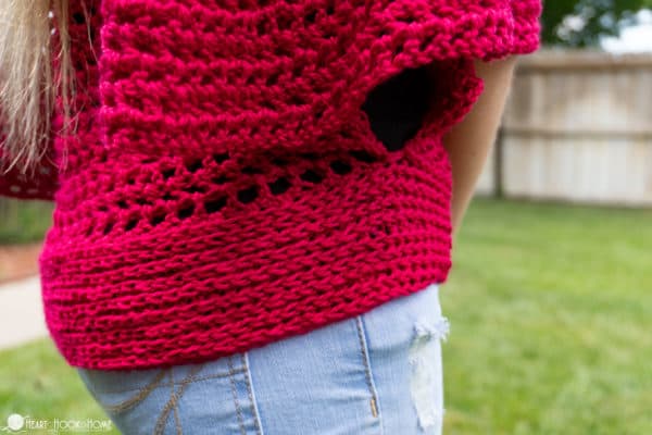 Red example of the Kids Flowy Top crochet pattern on a child wearing jeans.