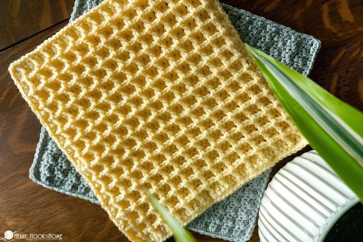 Image depicts two squares of crochet, the top one done in waffle stitch crochet.