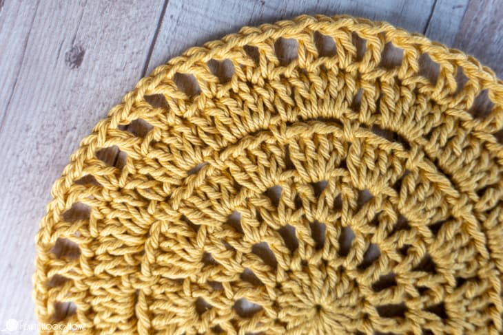 Sample of the Outdoor Table Mat crochet pattern in a gold colorway.