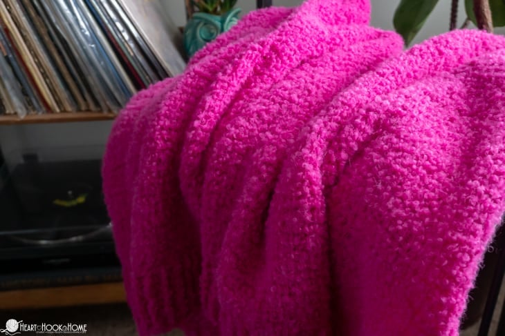 Close up of the Odette Cardi showing the texture of the bright pink Boucle yarn.