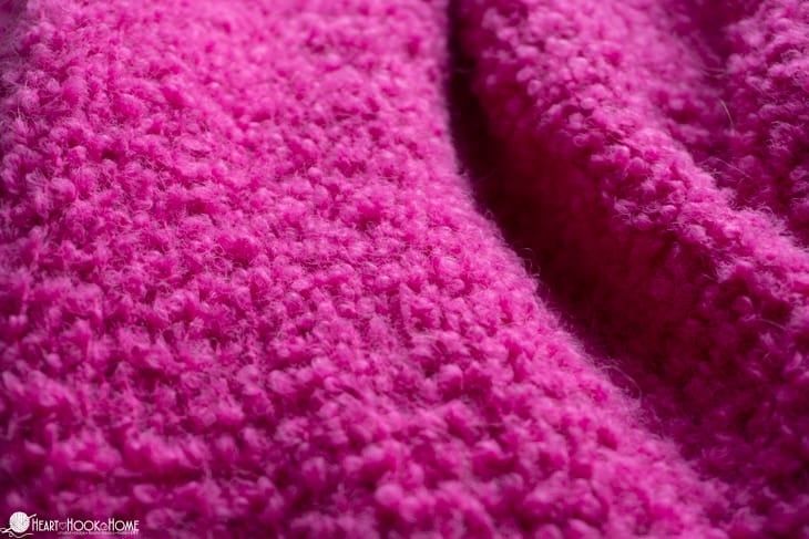 Sample of the Odette Cardigan in \"Popping Candy\" colorway of the Boucle Yarn from WeCrochet.