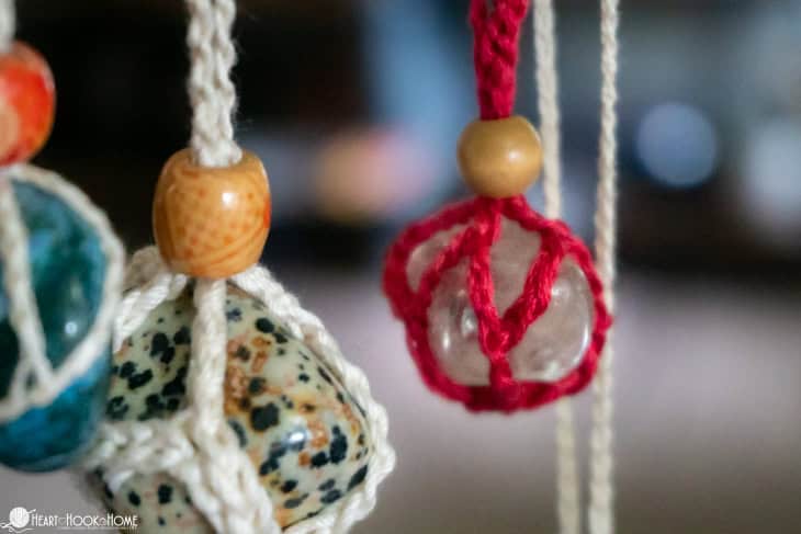 Multiple colors of stones and colorways of the Gemstone Holder crochet pattern.