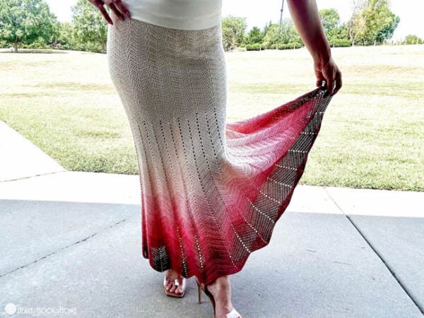Female model wearing an example of the Maxine Chevron Skirt crochet pattern in Rhubarb and Cream and Cream colorways of Twister yarn from Hobbii.