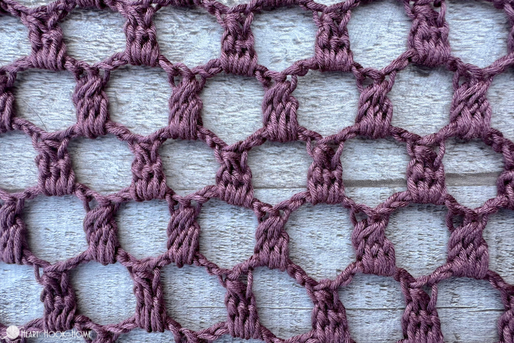 Sample of a purple colorway of the Edwardian Wrap crochet pattern.