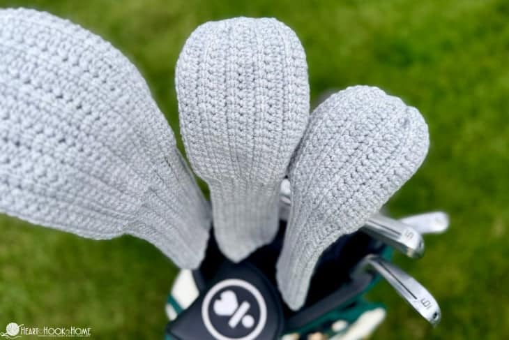 crocheted golf club covers over green grass