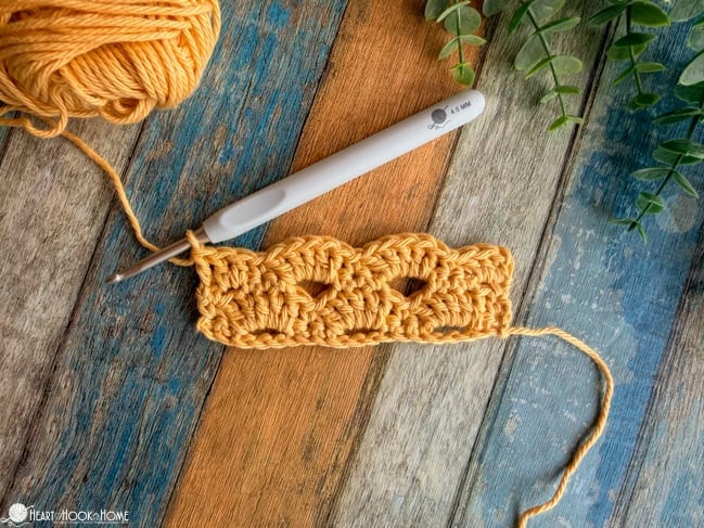 crochet arcade stitch sample using yellow yarn