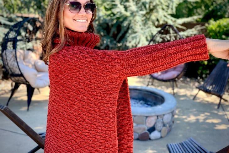 woman modeling the cuff on the almond poncho